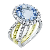 18K white and rose gold split shank ring with an oval sapphire 3.4 ct. center, and 1.81 ctw. of diamonds in the halo and on the bands