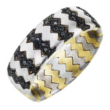 This distinctive men's band features a zig zag pattern in two tones of 14k gold set with .18 ctw of black diamonds.