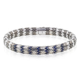 This men's bracelet in white gold and titanium zig zag pattern is accented by the perfect touch of 1.04 ctw of blue sapphires.