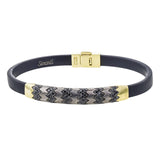 This men's bracelet features a pattern made from 14k yellow gold and titanium set with .57 ctw of black diamonds.