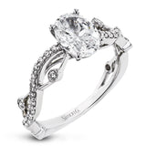 The intertwined design of this 18k gold engagement ring perfectly offsets an oval shaped center stone.
