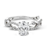 The intertwined design of this 18k gold engagement ring perfectly offsets an oval shaped center stone.