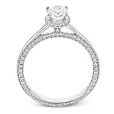 This engagement ring is made from an oval center stone and features a low halo as well as diamonds extended down the sides of the ring.