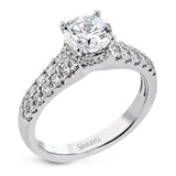Shining white diamonds encircle the center stone in this Underhalo engagement ring, while also extending across the sides of the ring to ensure it glitters from all directions.