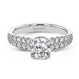 Shining white diamonds encircle the center stone in this Underhalo engagement ring, while also extending across the sides of the ring to ensure it glitters from all directions.