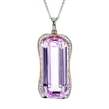 This incredible one-of-kind pendant features a pinky-lilac 28.09 ct kunzite gemstone accented by .15 ctw of white diamonds in an organic design.