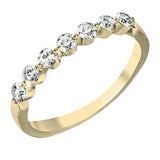 The perfect compliment to a solitare, this 7-stone diamond wedding band in 14K yellow gold adds just the right amount of sparkle