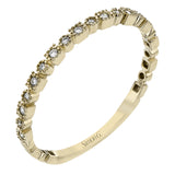 This diamond band in 14K yellow gold doubles as a stackable ring or a wedding band with 0.09 ctw of diamonds