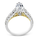 A touch of 18k yellow gold filigree on the interior of this ring adds a special touch to this 18k white gold engagement ring made for a marquise shape center stone.