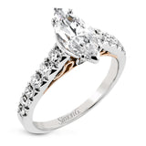 A touch of 18k yellow gold filigree on the interior of this ring adds a special touch to this 18k white gold engagement ring made for a marquise shape center stone.