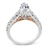 A touch of 18k yellow gold filigree on the interior of this ring adds a special touch to this 18k white gold engagement ring made for a marquise shape center stone.