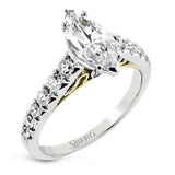 A touch of 18k yellow gold filigree on the interior of this ring adds a special touch to this 18k white gold engagement ring made for a marquise shape center stone.