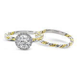 This ring is a twist on a halo engagement ring, with 18k yellow and white gold intertwining in the band.