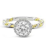 This ring is a twist on a halo engagement ring, with 18k yellow and white gold intertwining in the band.