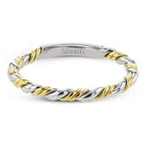 This ring is a twist on a halo engagement ring, with 18k yellow and white gold intertwining in the band.