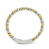 This ring is a twist on a halo engagement ring, with 18k yellow and white gold intertwining in the band.