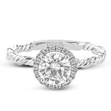 This ring is a twist on a halo engagement ring, with 18k yellow and white gold intertwining in the band.
