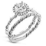 This ring is a twist on a halo engagement ring, with 18k yellow and white gold intertwining in the band.