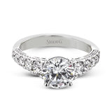 Filigree details underneath the center stone and diamonds that extend down the sides of this ring make it far from ordinary.