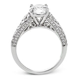 Filigree details underneath the center stone and diamonds that extend down the sides of this ring make it far from ordinary.