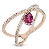 This modern 18k rose gold ring features a .61 ctw pear shaped ruby stone set against an angle, and is accented by .22 ctw of white diamonds.