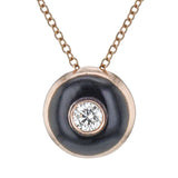 Shiny enamel surrounds the center .11 ct diamond in this dainty pendant, perfect for every day wear.