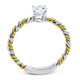 White and yellow 18k gold twine around each other in this ring that puts a twist on a classic design.