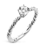 White and yellow 18k gold twine around each other in this ring that puts a twist on a classic design.