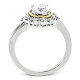 Full of interesting design details, this engagement ring from our Supernova collection features a yellow gold milgrain halo around the center stone, and an outer halo set with .20 ctw of white diamonds.