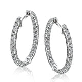 A full 1.00 ctw of diamonds line both in the inside and outside of these remarkable 18k white gold hoop earrings.