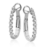 Day to night, the perfect transitional earring, these oval hoops are available in 18K white, yellow and rose gold and feature .32cttw round white diamonds.