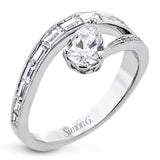 Like lightning zig-zagging across the sky, this dynamic 18k white gold ring contains a flowing line of .62 ctw baguette diamonds and one .55 ct pear shaped diamond set at an angle.