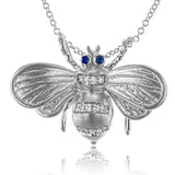 18K WG bee pendant stuns with a brushed textured finish and has 0.06 ctw diam, 0.03 ctw sapphires for eyes on an 18 chain