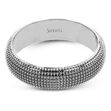 This 14k gold band features a granulated surface that is hand-created by experienced artisans.