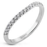 This criss-cross design engagement ring shimmers with 0.15 ctw round diamonds and a halo of gold strands wrapped around the center