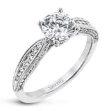 Delightful details abound in this 18k white gold engagement ring, set with .33 ctw of side diamonds.