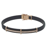 This bold bracelet features black rubber with 14k gold accents set with .35 ctw of white diamonds.