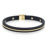 A sleek line of .39 ctw of diamonds makes a statement in this black rubber bracelet with 14k gold elements.