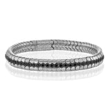 This sinuous 14k gold bracelet is set with .69 ctw of white diamonds.