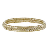 This sinuous 14k gold bracelet is set with .69 ctw of white diamonds.