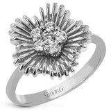 This unique two tone ring features polished gold wires evoking a starbust design, and has a center cluster of diamonds 0.23 ctw.