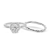 This ring is certainly a twist on a classic, with the band and halo formed from two tones of 18k gold twisted together, and the engagement ring set with .18 ctw of diamonds.