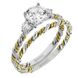 Wrap this ring around your finger for a distinctive style statement sure to stand the test of time- yellow and white 18k gold twisted together with .24 ctw of white diamond side stones.