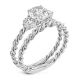 Wrap this ring around your finger for a distinctive style statement sure to stand the test of time- yellow and white 18k gold twisted together with .24 ctw of white diamond side stones.