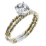 Two tones of 18k gold twist around each other in this contemporary yet timeless engagement ring.