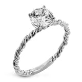 Two tones of 18k gold twist around each other in this contemporary yet timeless engagement ring.