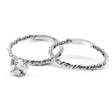 Two tones of 18k gold twist around each other in this contemporary yet timeless engagement ring.