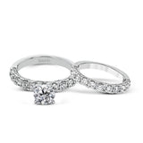 This engagement ring is stunning from every side, with .97 ctw of white round diamonds on the top and sides of the ring.