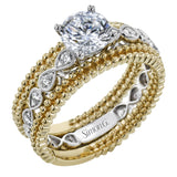 This wedding set features a white gold vintage inspired engagement ring in the center with a yellow gold granulated ring guard that provides a unique look.