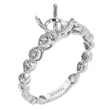 This wedding set features a white gold vintage inspired engagement ring in the center with a yellow gold granulated ring guard that provides a unique look.